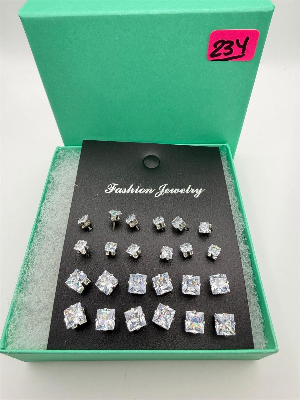 12 pairs of square rhinestone earrings from Republic Mercantile, featuring sparkling, elegant jewelry with a modern geometric design.