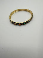 Gold ladies bangel bracelet with rainbow gemstone accents, featuring a stylish and elegant design by Republic Mercantile.