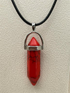 Red stone crystal point pendant necklace with silver chain from Republic Mercantile, showcasing a polished teardrop-shaped gemstone.