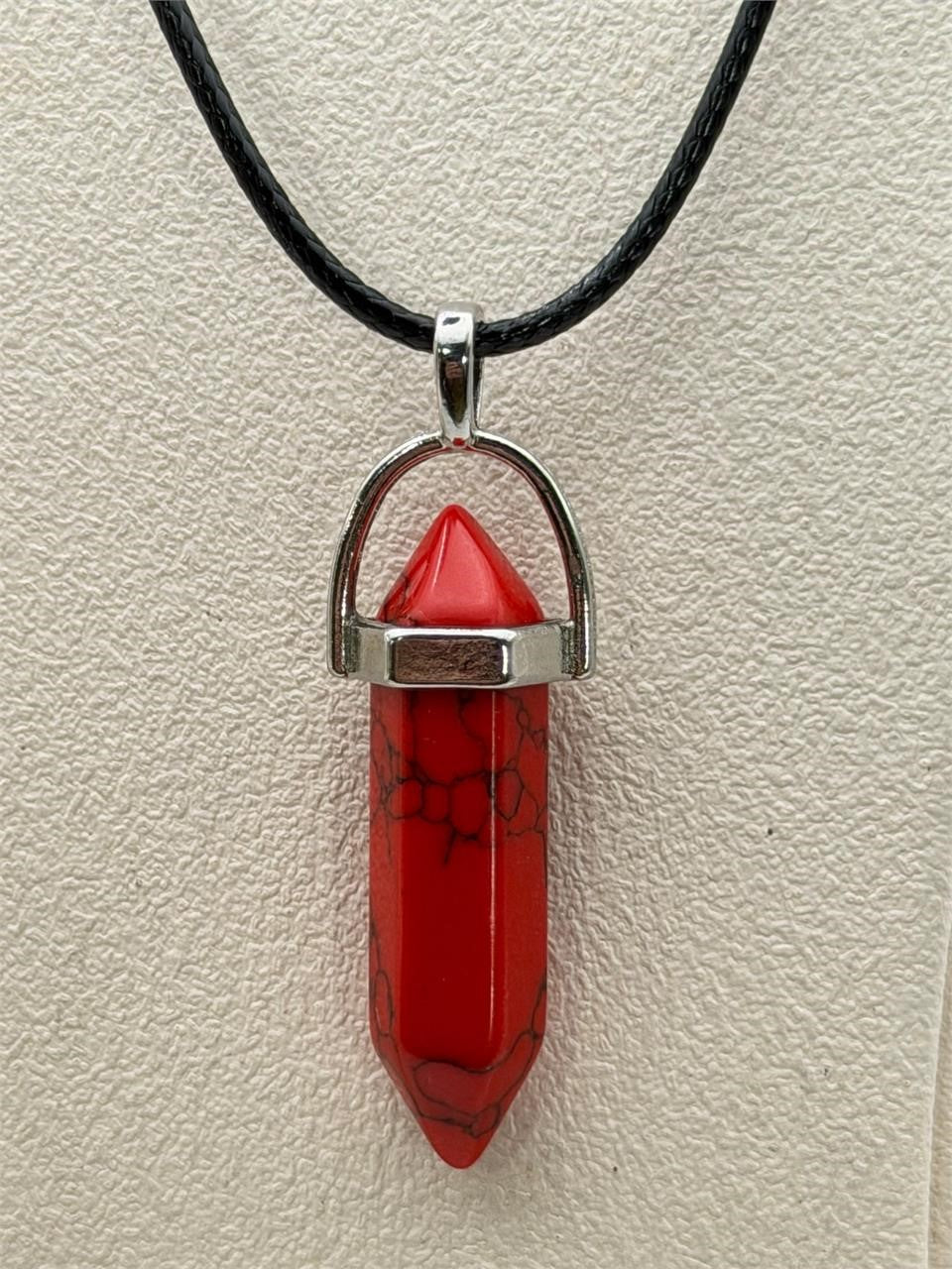 Red stone crystal point pendant necklace with silver chain from Republic Mercantile, showcasing a polished teardrop-shaped gemstone.