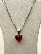 Silver heart gemstone pendant necklace with a chain, featuring a sparkling gemstone set in a delicate design.