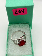 Sterling silver women's ring with a red spinel solitaire gemstone in size 7, featuring a sleek and elegant design.