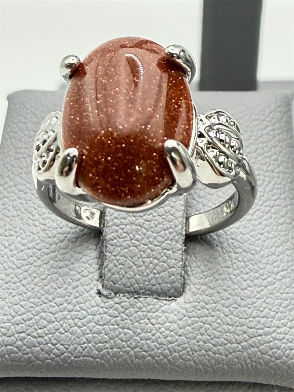 Sterling silver women's ring with copper goldstone gemstone, size 6, featuring a polished band and vibrant, sparkling stone.