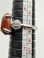 Sterling silver women's ring with copper goldstone gem, size 6, from Republic Mercantile, featuring a polished band and vibrant gemstone.