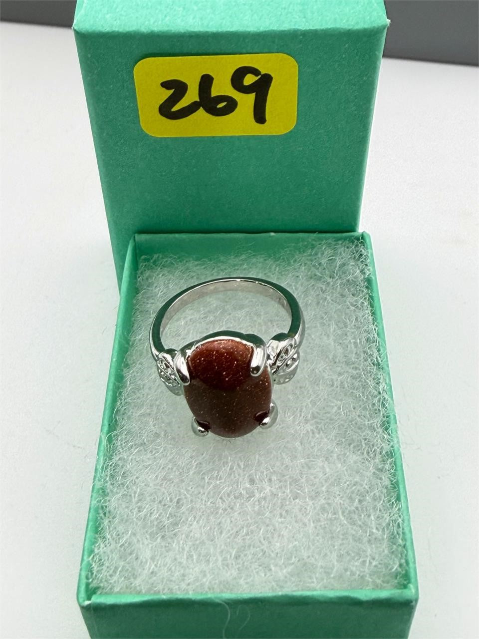 Sterling silver women's ring with copper goldstone gemstone, size 6, featuring a polished band and sparkling blue gemstone.