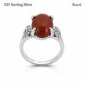 Sterling silver women's ring with copper goldstone gem, size 6, featuring a polished band and vibrant gemstone detail.