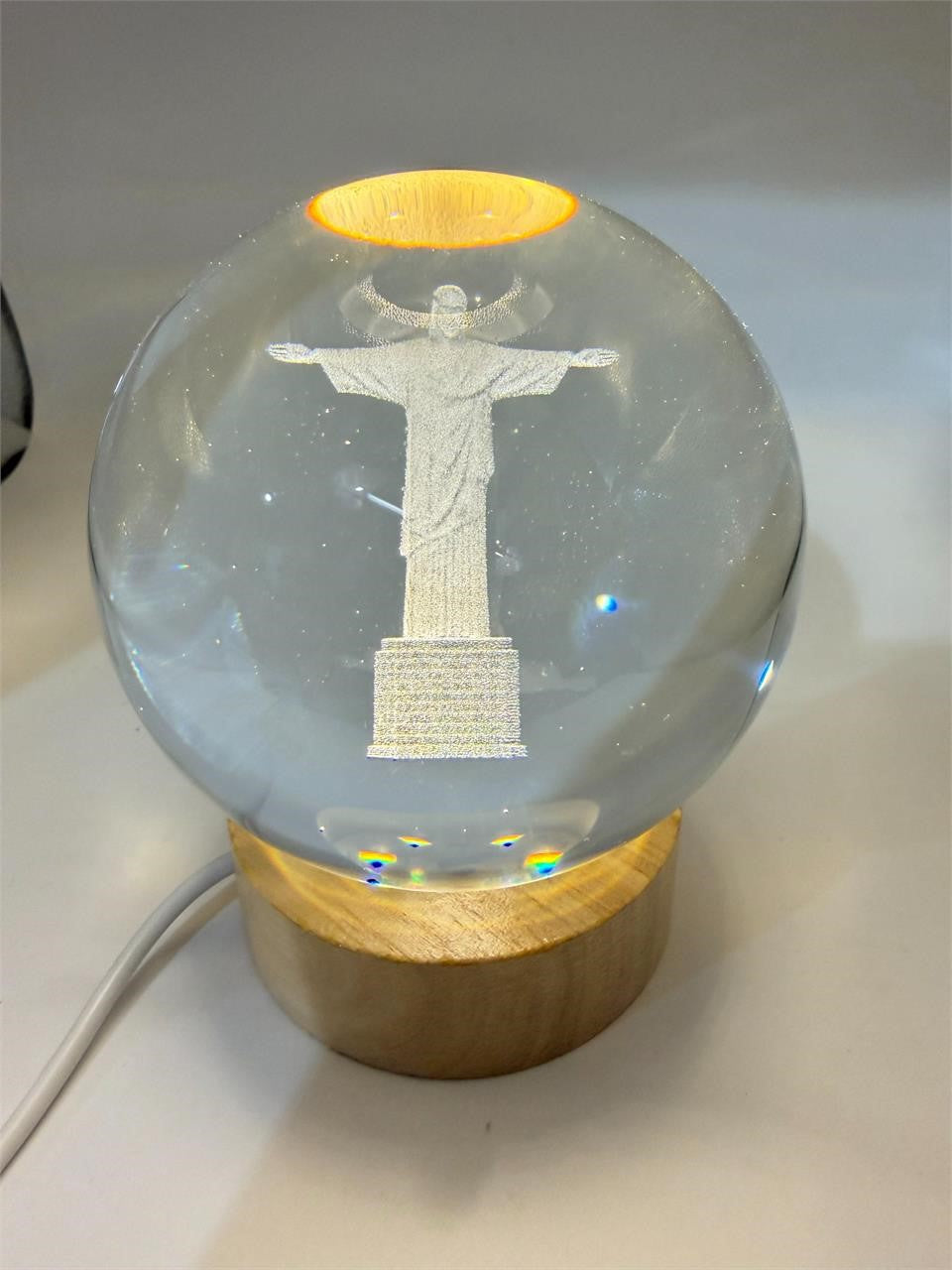 Laser etched crystal ball with LED stand featuring Christ design, Republic Mercantile product, clear glass with detailed engraving.