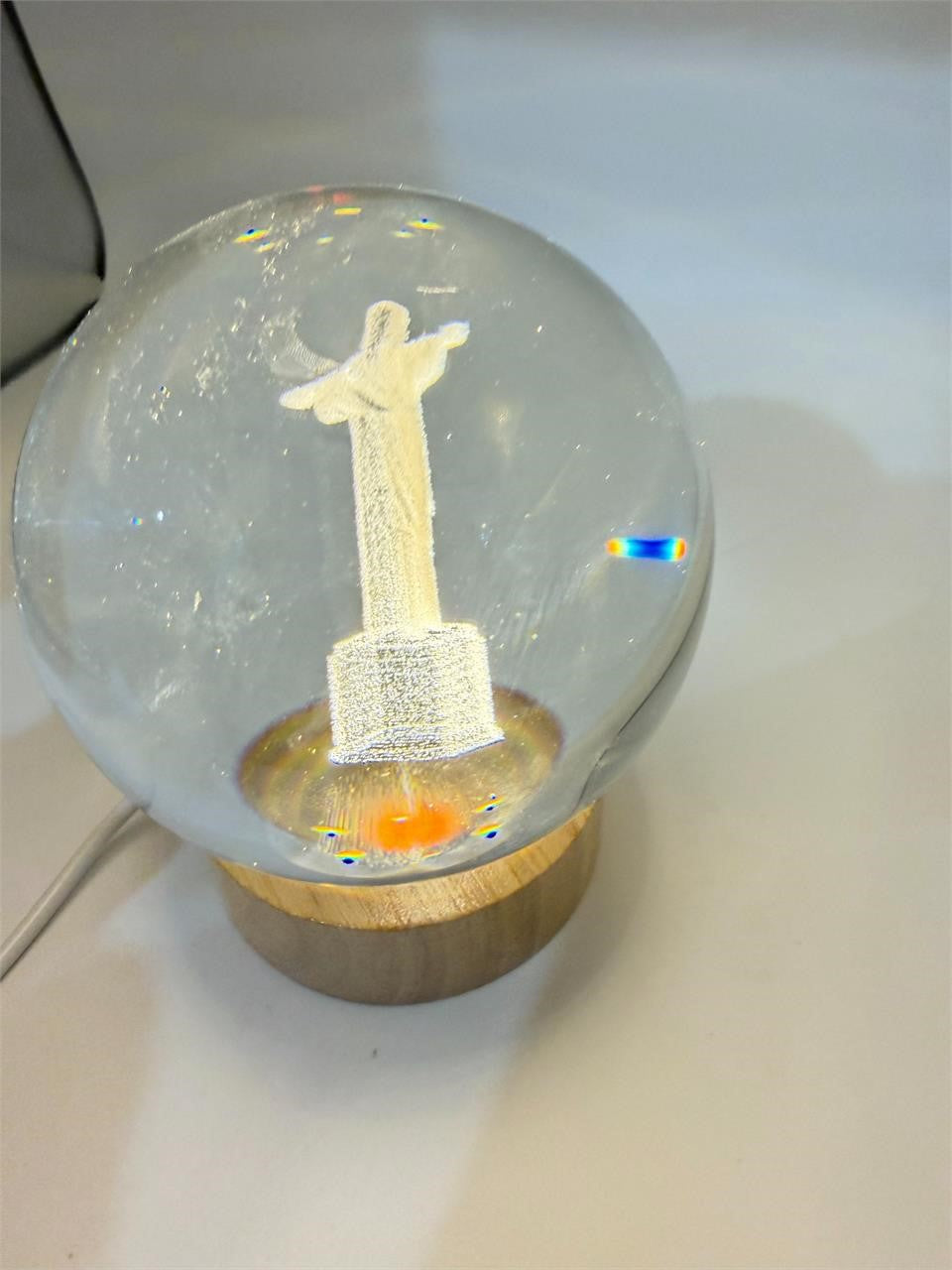 Laser etched crystal ball with LED stand displaying a Christ design, made by Republic Mercantile.