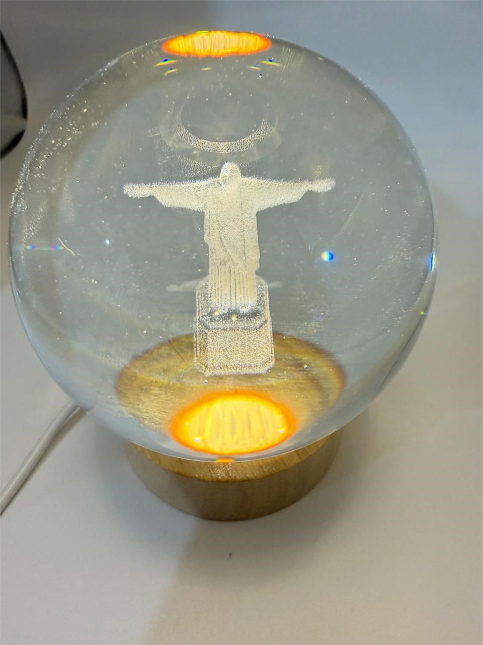 Laser etched crystal ball with LED stand featuring Christ design, crafted by Republic Mercantile.