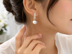 Elegant pearl drop fashion earrings by Republic Mercantile featuring dangling white pearls on silver hooks.