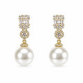 Elegant pearl drop fashion earrings by Republic Mercantile, featuring lustrous pearls and delicate metal hooks for a sophisticated look.