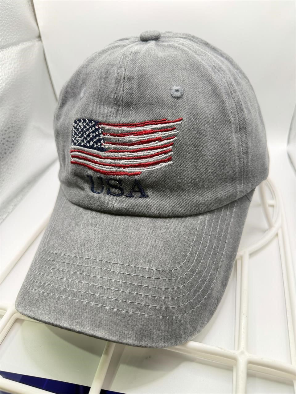 Light gray washed USA ball cap hat by Republic Mercantile, showing front view with adjustable strap and distressed fabric.