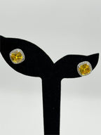 Republic Mercantile yellow crystal stud earrings featuring cushion halo design, sparkling in a jewelry display.