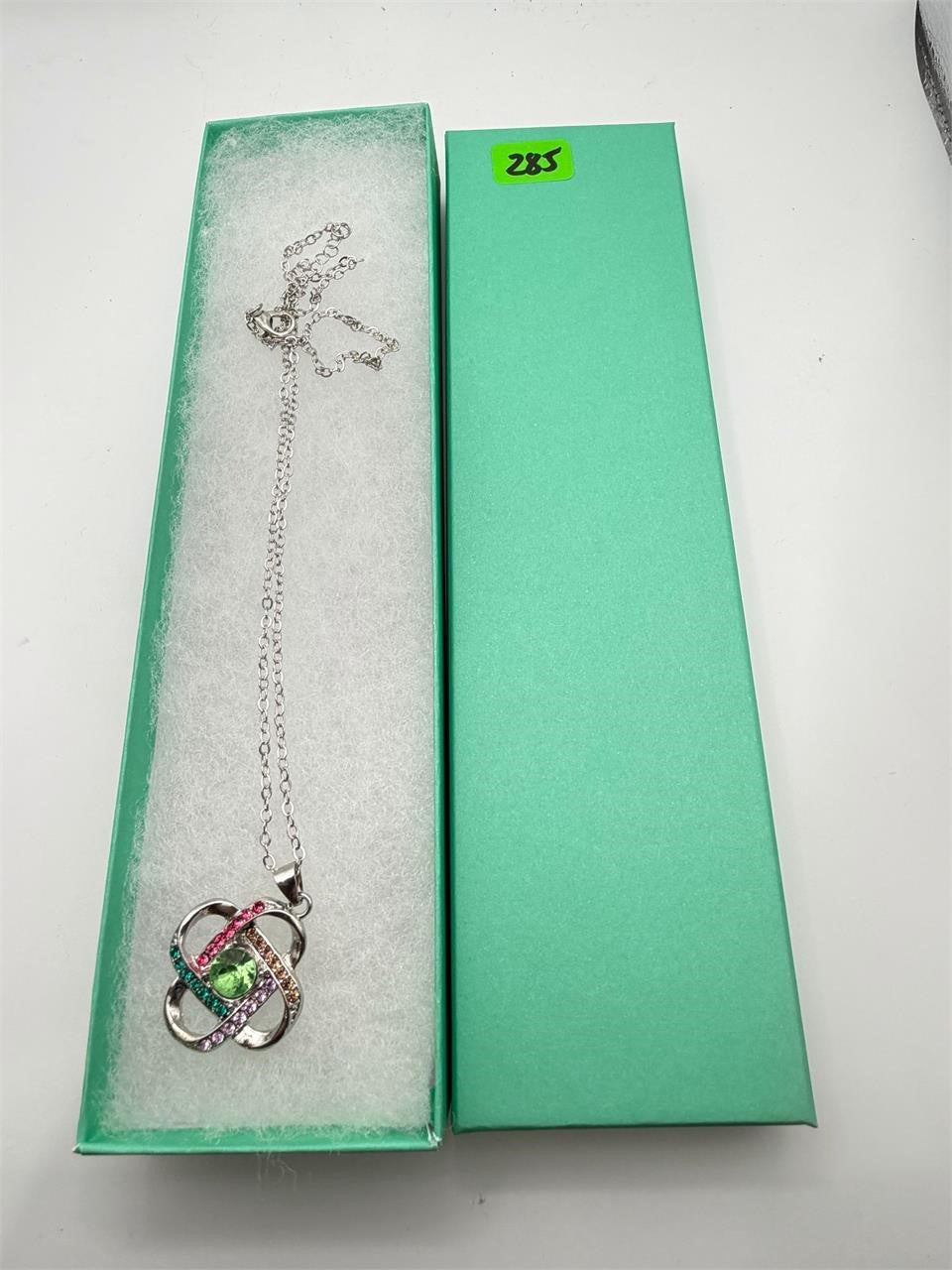 Multicolor crystal gem pendant necklace with silver chain from Republic Mercantile, close-up showing vibrant, sparkling stones.