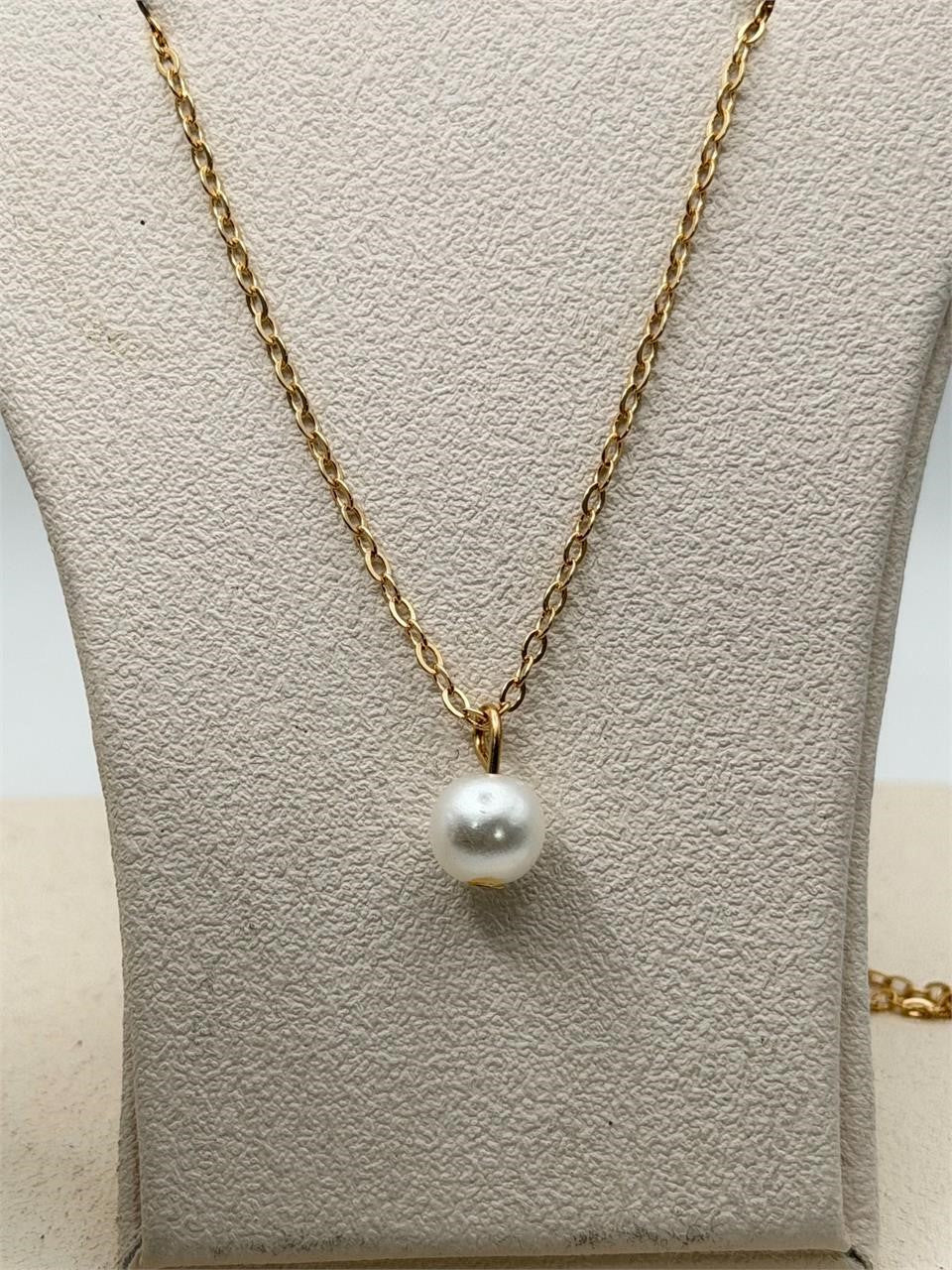 Gold tone chain necklace with single pearl pendant from Republic Mercantile, featuring a stylish and elegant jewelry design.