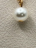 Gold tone chain necklace with single pearl pendant from Republic Mercantile, stylish fashion jewelry accessory.