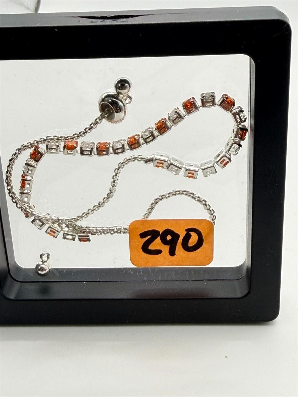 Women's silver-tone bolo tennis bracelet with orange and clear crystals, stylish jewelry by Republic Mercantile.