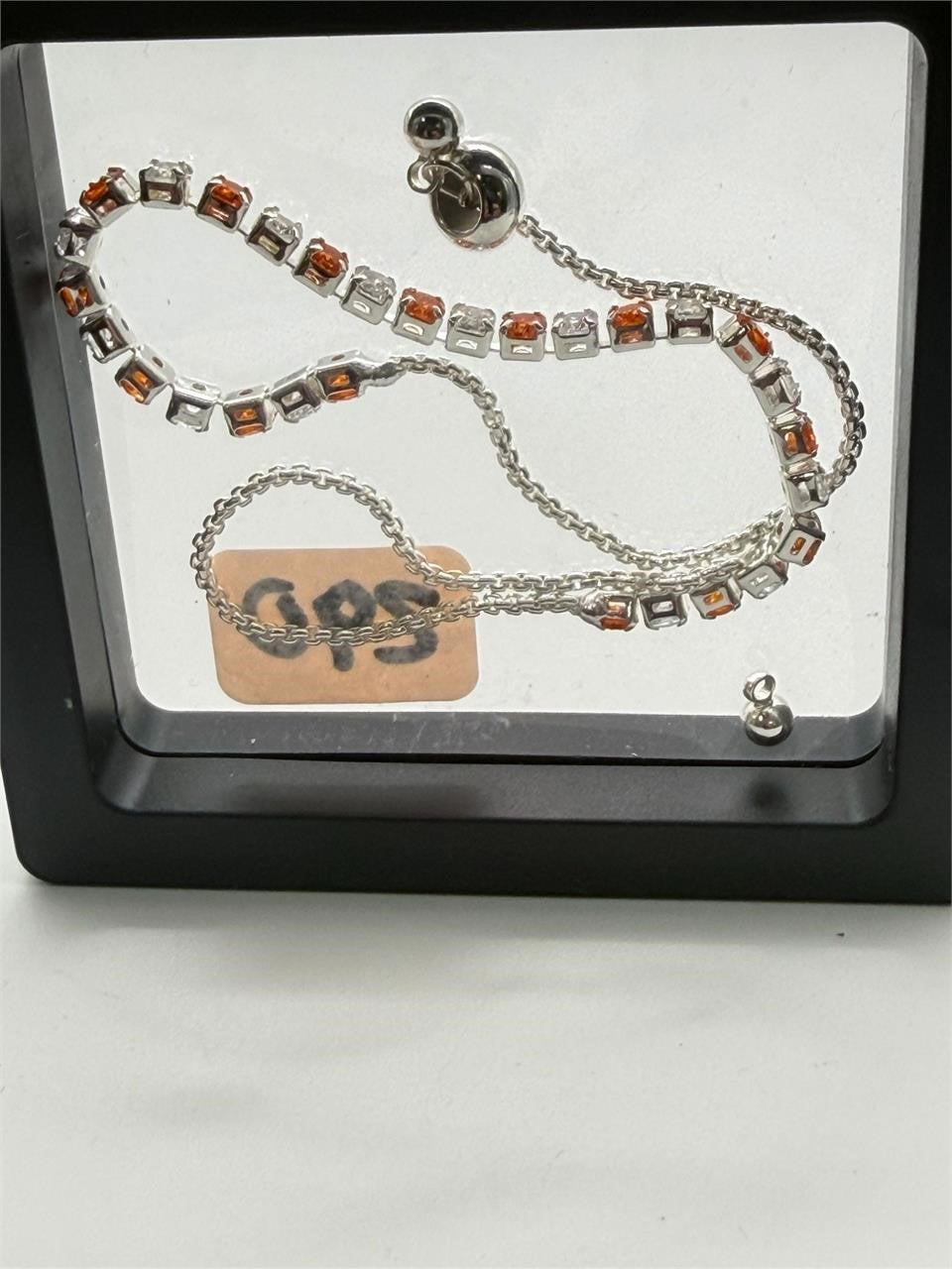 Women's silver-tone bolo tennis bracelet with orange and clear crystals, stylish jewelry by Republic Mercantile.