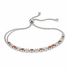 Silver-tone women's bolo tennis bracelet with orange and clear crystals, featuring a sleek and elegant design.