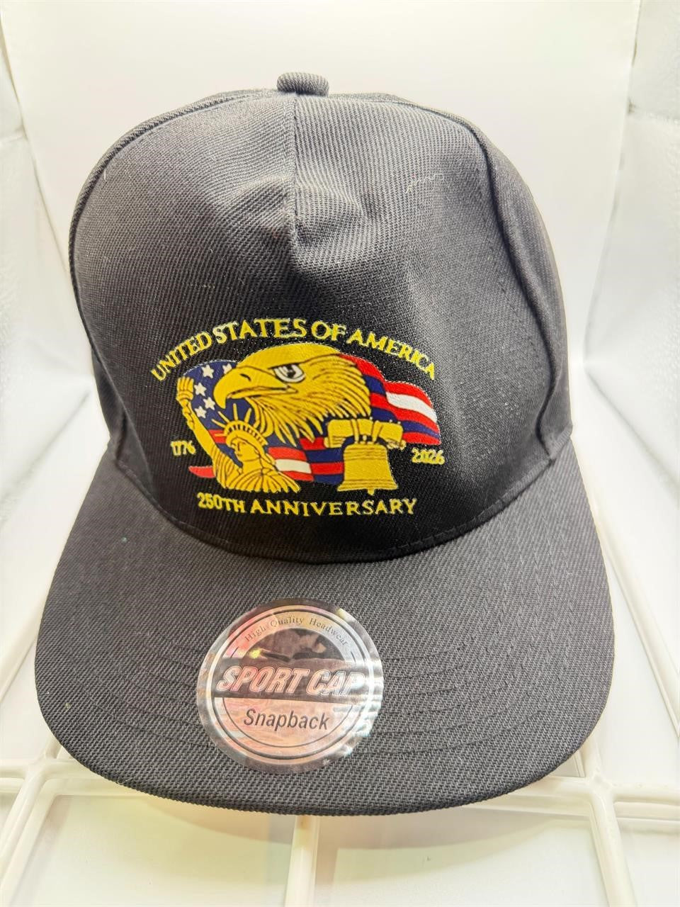 Black 250th Anniversary Snapback ball cap with embroidered logo, adjustable strap, and flat brim.