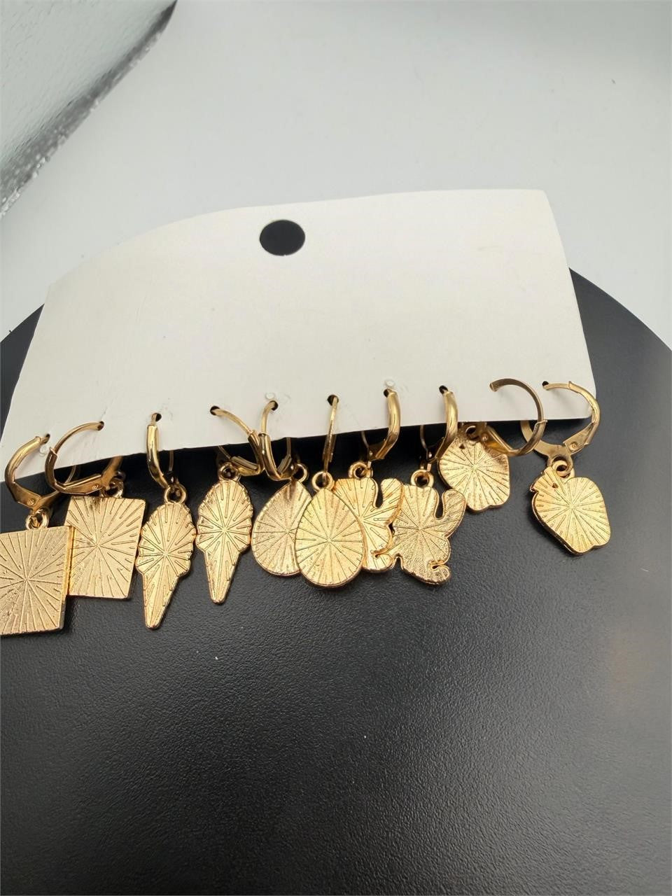 Five pairs of gold-tone USA flag earrings with star and stripe design, stylish patriotic jewelry from Republic Mercantile.