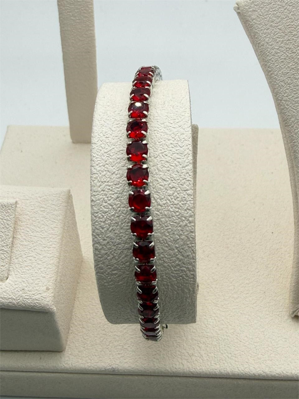 Red crystal silver-tone fashion bracelet with clasp lock, stylish accessory by Republic Mercantile, featuring sparkling crystals and sleek design.