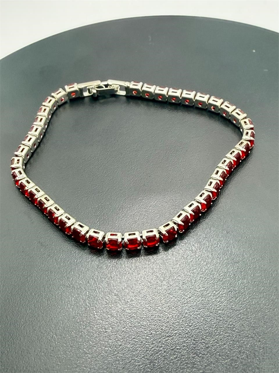 Red crystal silver tone fashion bracelet with clasp lock, stylish jewelry by Republic Mercantile, close-up view.
