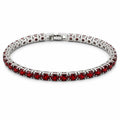 Red crystal silver-tone fashion bracelet with clasp lock, stylish jewelry piece featuring sparkling red stones and elegant silver finish.