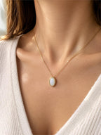Iridescent opal-style oval pendant necklace from Republic Mercantile featuring a shimmering, colorful gemstone on a silver chain.