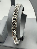 Men's Cuban link stainless steel bracelet from Republic Mercantile, close-up view showing shiny, interlocked chain design.