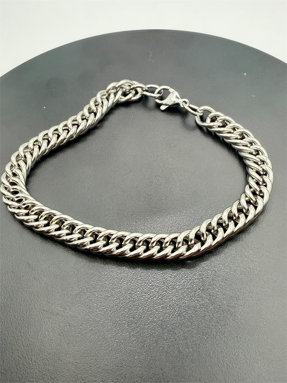 Men's stainless steel Cuban link bracelet by Republic Mercantile, showcasing shiny, interlocking chain design.
