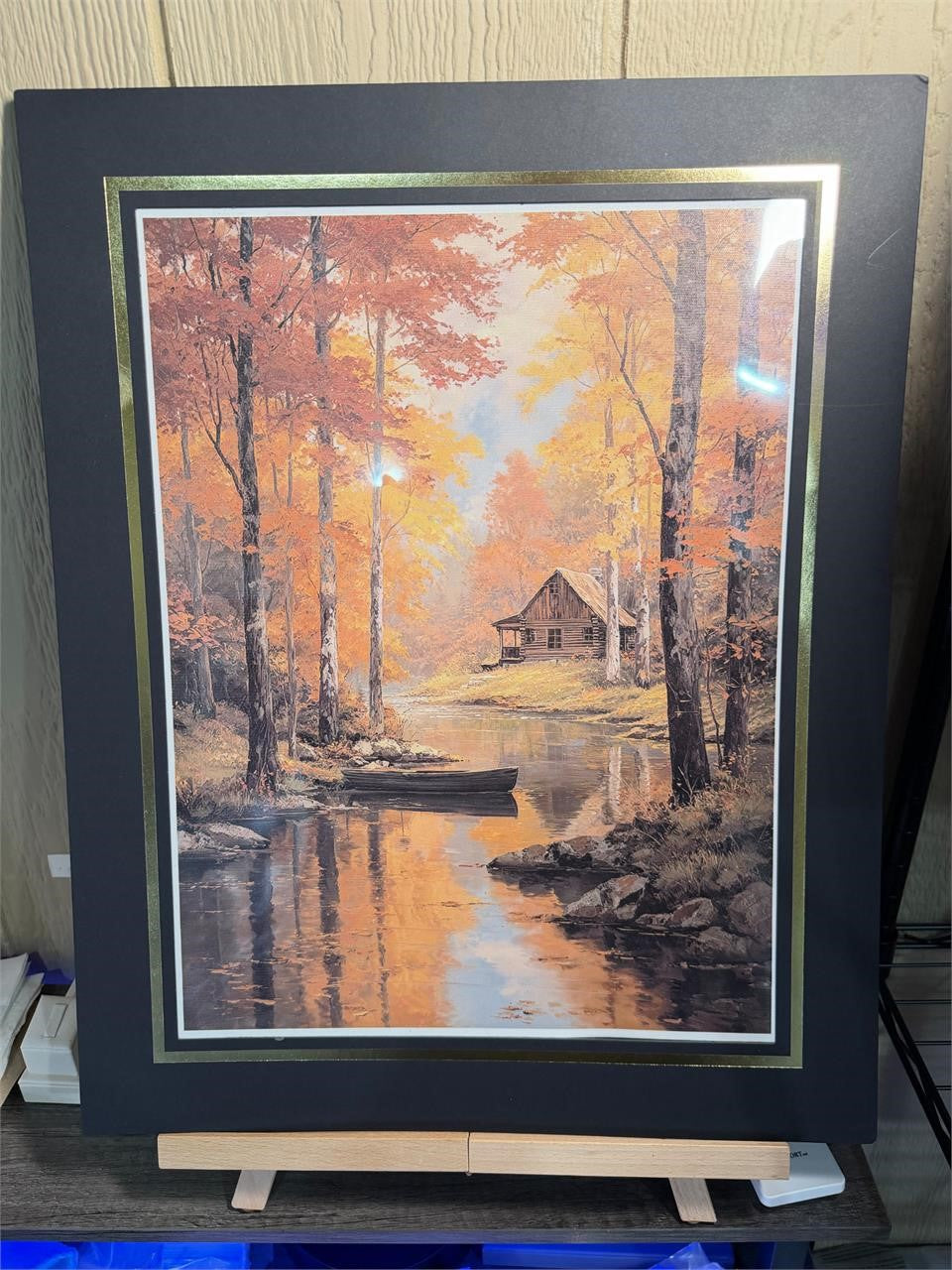 12x16 inch canvas art print of a cabin, displayed with a 16x20 black mat in a Republic Mercantile portfolio.