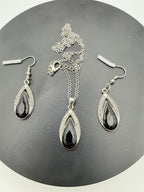 Black Onyx teardrop necklace and earrings set with silver accents, featuring elegant jewelry by Republic Mercantile.
