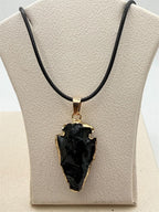 Black arrowhead pendant necklace with gold tone finish from Republic Mercantile, featuring a sleek, modern design.