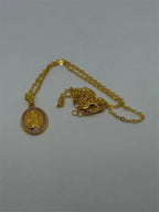 Virgin of Guadalupe pendant on a golden chain, featuring detailed religious iconography and intricate gold craftsmanship.
