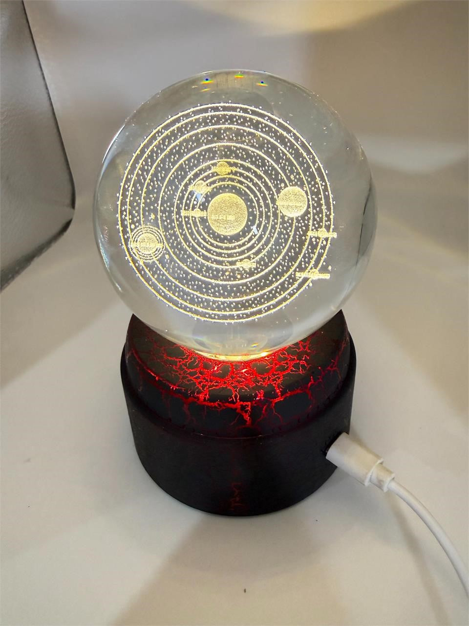 Etched crystal ball with LED lighting on a rotating stand, decorative Republic Mercantile crystal sphere for display or ambiance.
