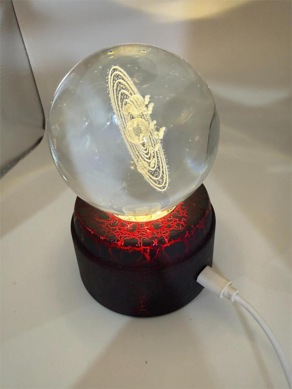 Etched crystal ball with LED lighting and rotating stand by Republic Mercantile, showcasing intricate designs and vibrant illumination.