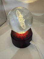 Etched crystal ball with LED lighting and rotating stand by Republic Mercantile, showcasing intricate designs and vibrant illumination.