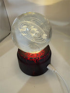 Etched crystal ball with LED lighting on a rotating stand, displayed by Republic Mercantile.