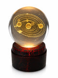 Etched crystal ball with LED lighting on a rotating stand, featuring intricate designs, by Republic Mercantile.