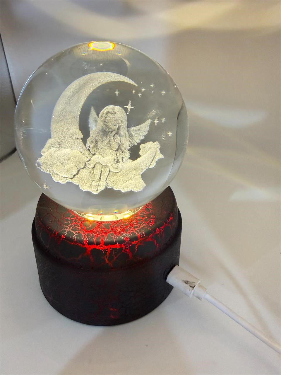 Etched crystal ball with LED lighting and rotating stand, decorative art piece by Republic Mercantile.