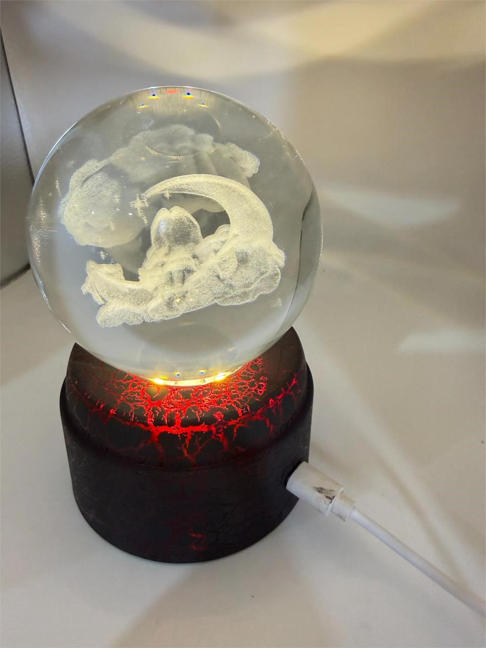 Etched crystal ball with LED lighting and rotating stand, Republic Mercantile decorative glass sphere for display or mystical decor.