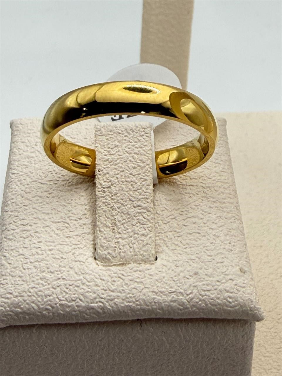 Stainless steel gold tone band ring in size 8, featuring a sleek, polished design with a smooth finish.