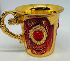 Red enamel jeweled brass cup with red stones, decorative Republic Mercantile drinkware featuring intricate details and vibrant colors.