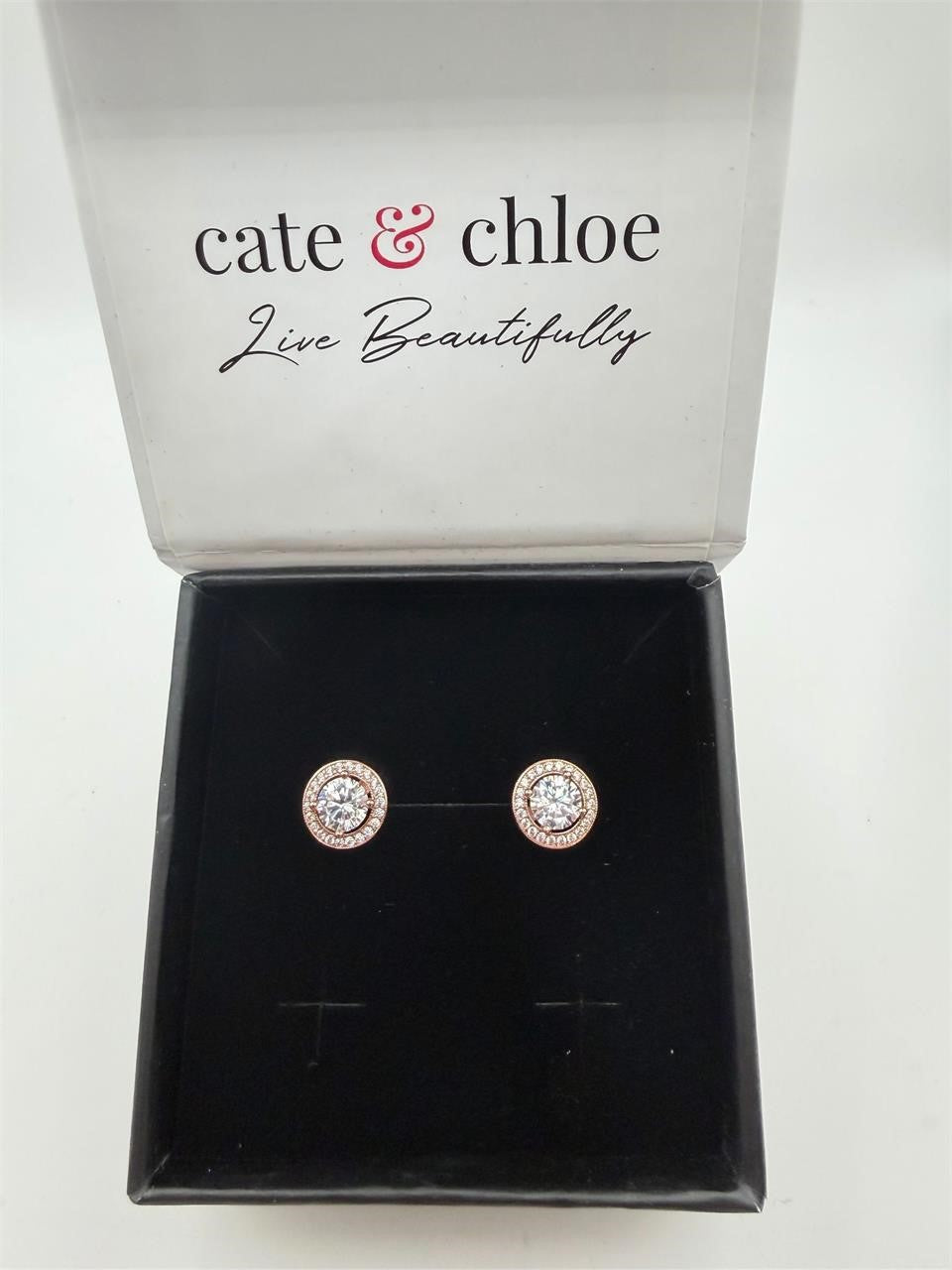 Cate & Chloé rose gold earrings with sparkling moissanite stones, elegant jewelry design on a white background.