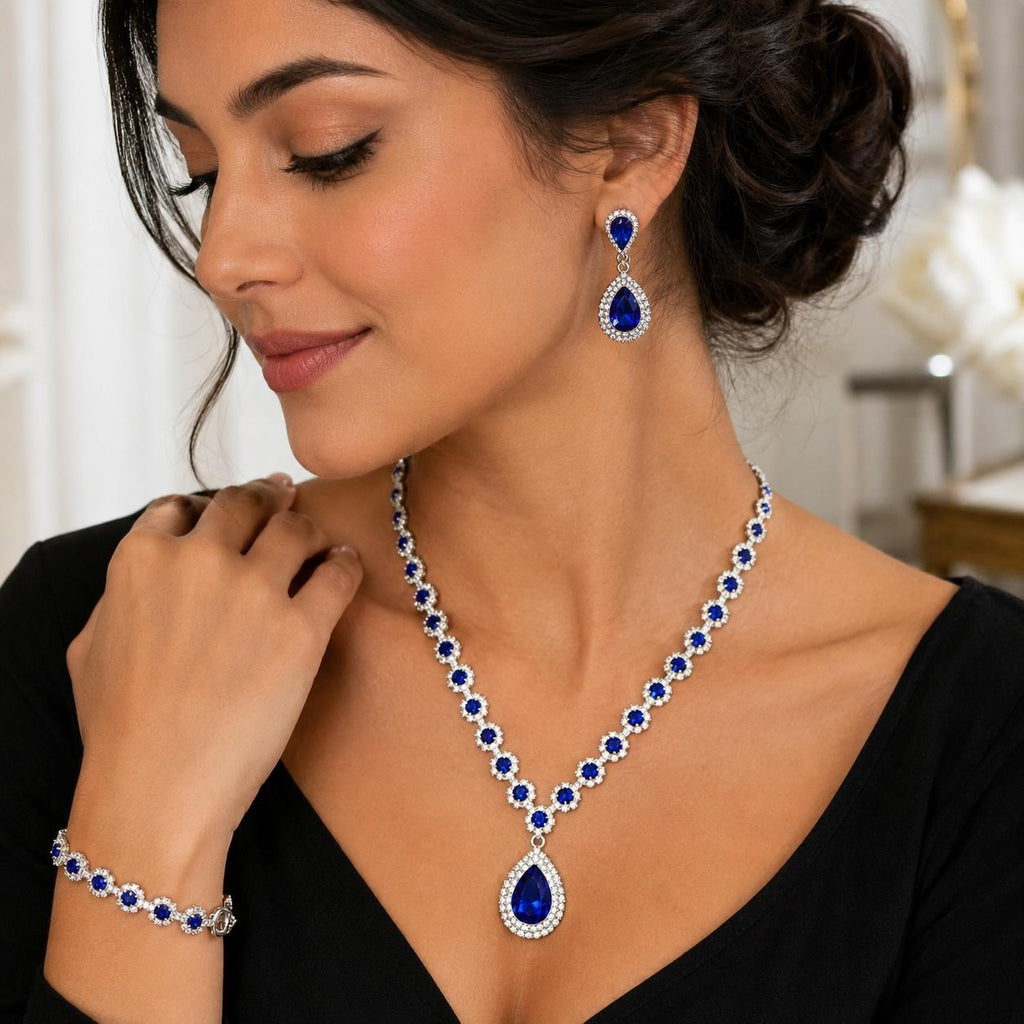 Four-piece fashion jewelry set with sapphire and diamond accents from Republic Mercantile, featuring elegant necklace, earrings, and bracelet.