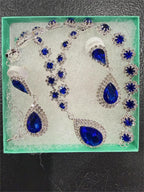 Four-piece fashion jewelry set featuring sapphire and diamond accents, including earrings, necklace, and bracelet by Republic Mercantile.