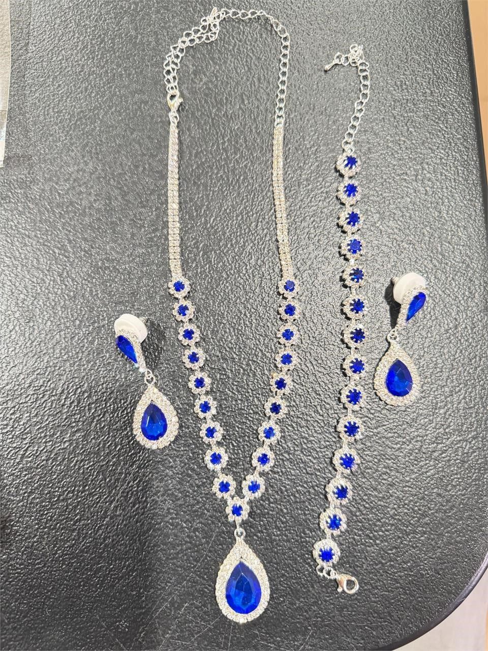Four-piece fashion jewelry set featuring sapphire and diamond accents, includes necklace, earrings, and bracelet from Republic Mercantile.
