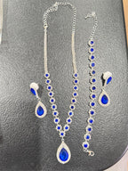 Four-piece fashion jewelry set featuring sapphire and diamond accents, includes necklace, earrings, and bracelet from Republic Mercantile.