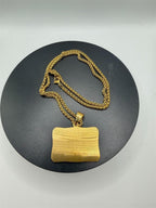 Gold Last Supper pendant with long chain jewelry by Republic Mercantile, featuring religious iconography and intricate design.